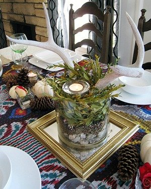 rustic wedding centerpiece with pinecones on a mirror